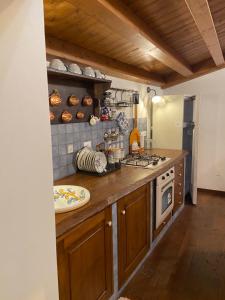 a kitchen with a stove and a counter top at Casa Portello in Montalbano Elicona