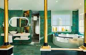 a bathroom with a tub and a sink at Hotel Boutique Cortijo Landete - SOLO ADULTOS in Granada