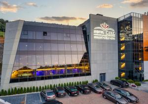 a parking lot in front of a car dealership at Hotel Meta Resort & Vine SPA in Szczyrk