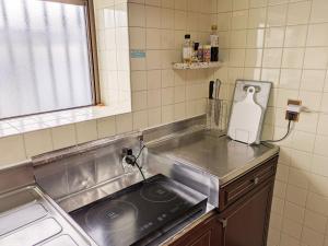 uma cozinha com um lavatório e uma bancada em nalu okinawa - Vacation STAY 00877v em Uruma