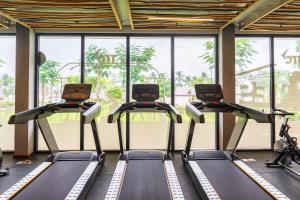 a row of treadmills in a gym with windows at TTC Van Phong Bay Resort - Himalaya Sauna & Steam Retreat Included in Ninh Hòa