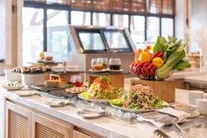 a buffet with plates of food on a table at TTC Van Phong Bay Resort - Himalaya Sauna & Steam Retreat Included in Ninh Hòa