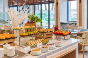 a buffet with many different types of food on display at TTC Van Phong Bay Resort - Himalaya Sauna & Steam Retreat Included in Ninh Hòa