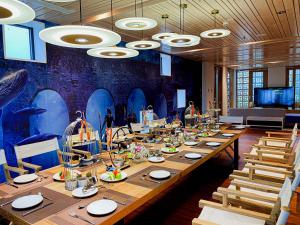 a long table in a room with people standing around it at TTC Van Phong Bay Resort - Himalaya Sauna & Steam Retreat Included in Ninh Hòa