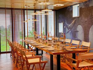 a long table in a room with chairs at TTC Van Phong Bay Resort - Himalaya Sauna & Steam Retreat Included in Ninh Hòa