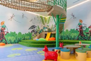 a childrens play room with a jungle mural on the wall at TTC Van Phong Bay Resort - Himalaya Sauna & Steam Retreat Included in Ninh Hòa