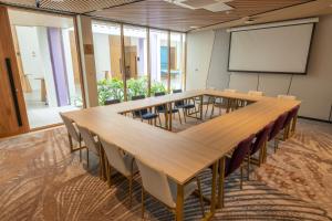 a conference room with a large table and chairs at TTC Van Phong Bay Resort - Himalaya Sauna & Steam Retreat Included in Ninh Hòa