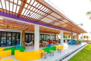 a covered patio with colorful chairs and tables at TTC Van Phong Bay Resort - Himalaya Sauna & Steam Retreat Included in Ninh Hòa