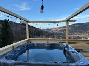 a hot tub on a roof with a view at Domek u Sołtyska in Rajcza