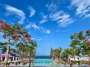 a view of the ocean from the pool at the resort at TTC Van Phong Bay Resort - Himalaya Sauna & Steam Retreat Included in Ninh Hòa