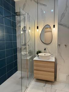 a bathroom with a sink and a glass shower at Sunshine Getaway - Stylish Studio in the Heart of Nice in Nice