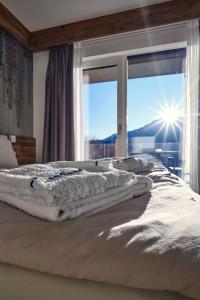 a bedroom with a bed with a view of a window at AGRITUR SEDICI - Bed and Breakfast in Tenna 