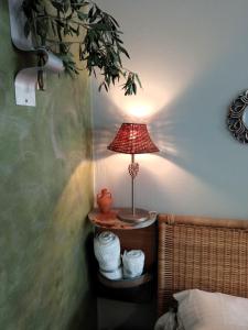 a lamp sitting on a table in a bedroom at Nix Nax Kalamata in Kalamata