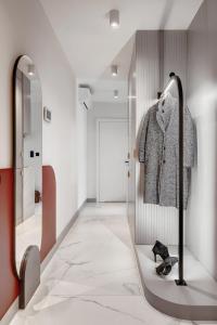 a dressing room with a mirror and a walk in closet at MameHome Apartments in Krakow