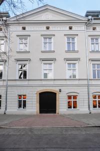 a large white building with a large garage at MameHome Apartments in Krakow