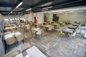 a dining room filled with tables and chairs at Çelik Thermal & Spa in Pamukkale