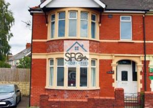 a red brick house with a sign on it at Spacious 4BR Home-8 Guests-Business-Families-Netflix-Free Parking & WiFi in Cardiff