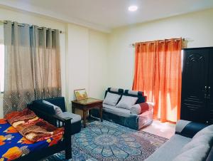 a living room with two couches and a table at Place where stay for good time in Ajman 