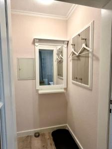 a bathroom with a mirror and a medicine cabinet at Nordsee 02 in Duhnen