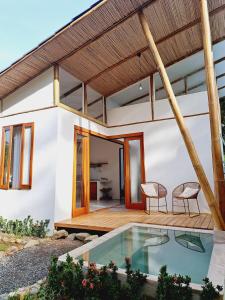 une maison avec une piscine en face de celle-ci dans l'établissement Casa Perezoso-Private pool- 800m from the beach., à Uvita