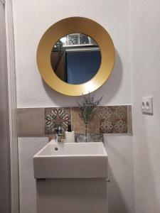 a bathroom with a sink and a mirror on the wall at LOS NOGALES in Cazalla de la Sierra