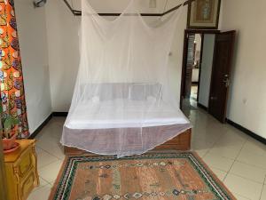 een bed met een witte baldakijn in een kamer bij Good Vibes Stay in Dar es Salaam