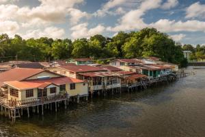 a group of houses on a dock on the water at The CentrePoint Hotel in Bandar Seri Begawan