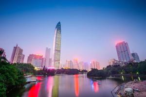 a city skyline with a river with a tall building at Chang An Hotel in Shenzhen
