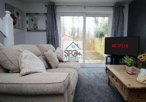 salon z kanapą i telewizorem w obiekcie Cosy 2BR Home-4 Guests-Business-Families-Netflix-Free Parking & WiFi w mieście Caerleon