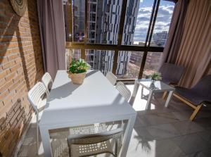 a white table and chairs on a balcony with a view at SOL 7 Levante Beach in Benidorm