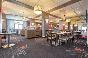 a dining room with tables and chairs in a restaurant at Best Western Plus Paris Orly Airport in Rungis