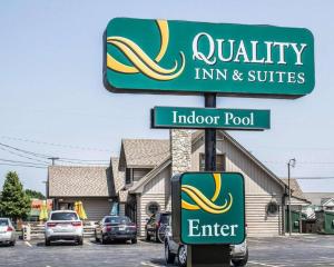a sign for an indore pool and a car dealership at Quality Inn & Suites in Sturgeon Bay