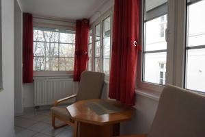 a room with two chairs and a table and windows at "Villa Rügen" - 300 m zum Strand in Binz