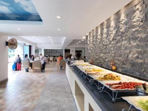 a buffet line with many plates of food on it at Lake Hills Sokrisan Hotel in Boeun