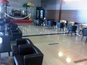 a waiting area with chairs and tables in a restaurant at Radja Hotel in Samarinda