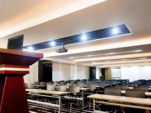 a large lecture hall with tables and chairs at Orient Sunseed Hotel Airport Branch in Fenghuangwei