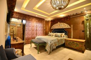 a bedroom with a bed and a chandelier at Dar Al Makam - Adult Only in Soliman