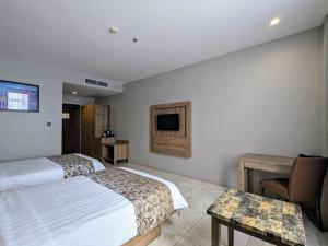 Säng eller sängar i ett rum på Grand Zuri Pematangsiantar