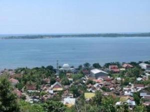 a town next to a body of water with houses at Hotel Delima Sari in Parepare