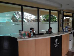 two people sitting at a counter in a restaurant at Bayfront Hotel Subic in Olongapo +44 photos