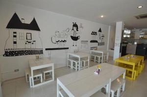 a room with tables and chairs and a building on the wall at U Style Hotel in Ban Phang Khwang Tai