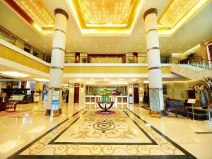 a lobby of a hotel with a large building at Qingdao Chengyang Detai Hotel in Qingdao