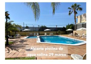a villa with a swimming pool in a resort at Hospedium Hotel Abril in San Juan de Alicante
