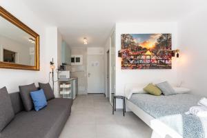 a living room with a bed and a couch at Apartamento Aguila 05 in Benalmádena