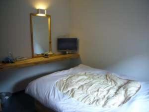 En eller flere senge i et værelse på Business Hotel Tsuwano
