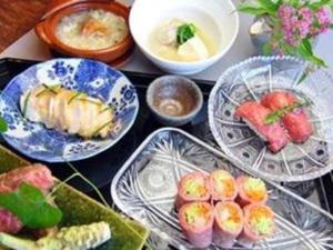 a table with plates of food and bowls of food at Hotel Shikino Kura in Kawazu