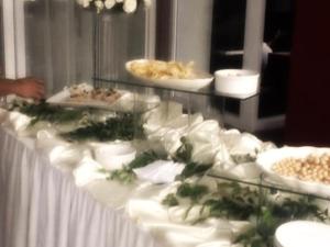 a buffet with white plates of food on a table at Regal Plaza Hotel in Nabua
