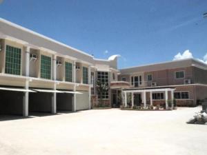 a large building with a courtyard in front of it at Regal Plaza Hotel in Nabua