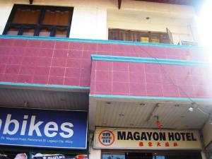 a building with pink tiles on the side of it at Magayon Hotel in Buenavista