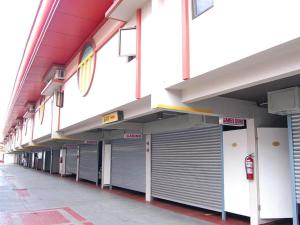an empty parking lot with metal garage doors on a building at Hotel Sogo Mexico Pampanga in San Fernando